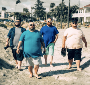 Four guys walking barefooted