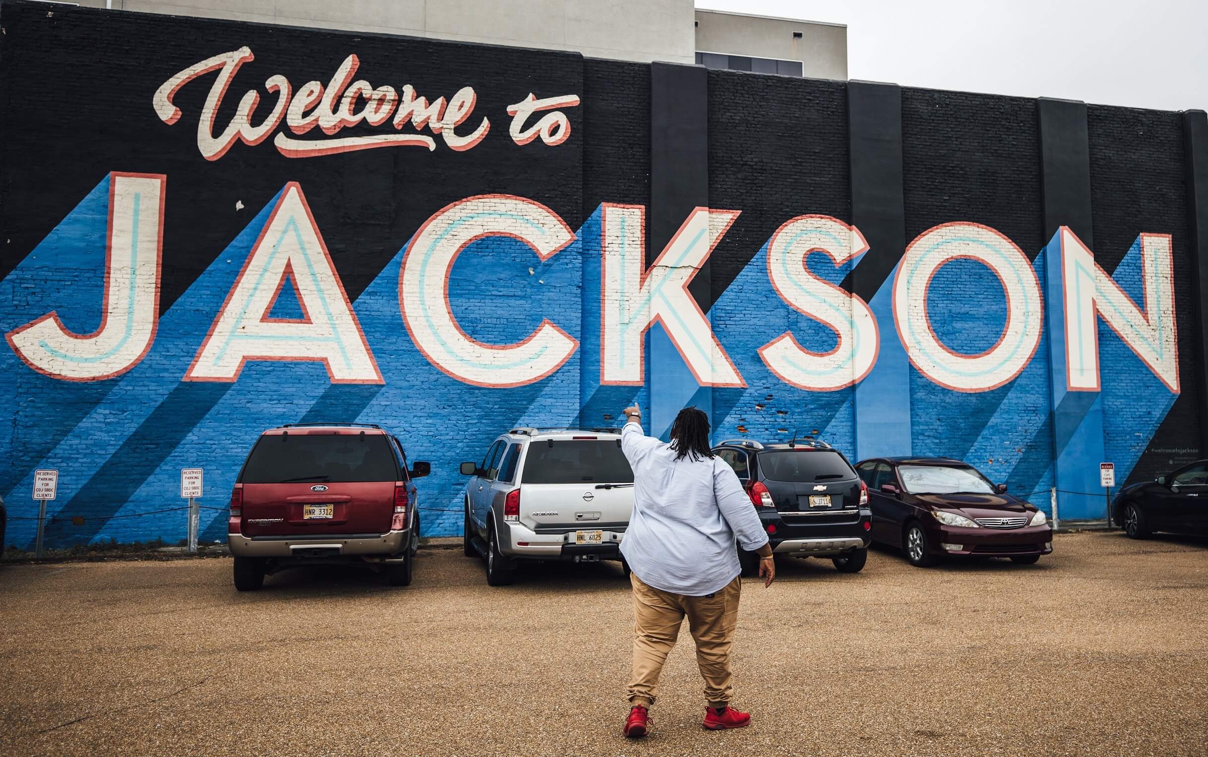 Jeff Jenkins in front of the Welcome to Jackson Mural